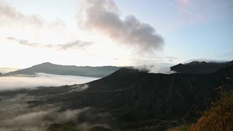 A group of clouds in the sky over a volcano Stock Footage 130765632