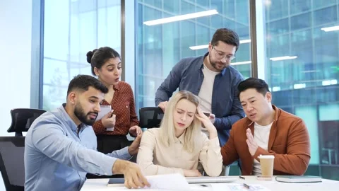 Group of co-workers supports stressed female worker at workplace in business  Video stock 301973438