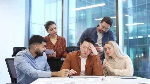 Group of co-workers supports stressed male worker at workplace in business offic Stock Footage 319069926