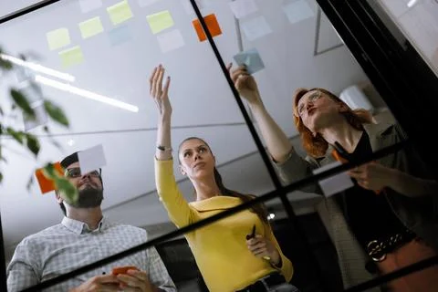 Group collaboration on project planning with sticky notes in a modern office Stock Photos