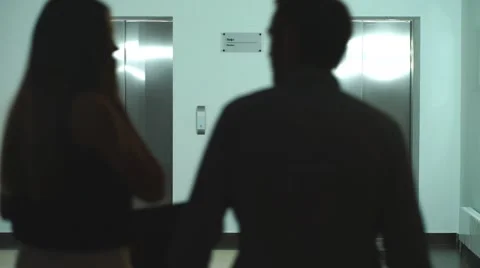 A group of colleagues awaits the Elevator in the lobby of the office Stock Footage 67495896