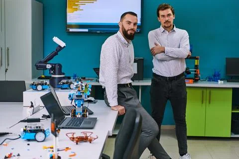 A group of colleagues collaborate in a lab while testing a 3D printer 写真素材
