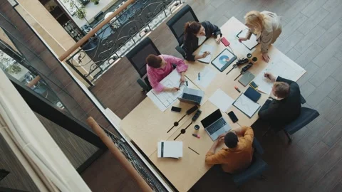 Group of colleagues is discussing project during meeting in modern coworking Stock Footage 244634022
