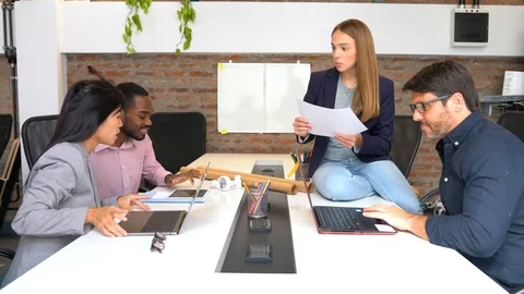 Group of colleagues discussing project ideas in modern office Stock Footage 101321866