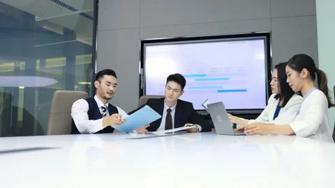 Group of colleagues having a work meeting in the boardroom, sitting around the Stock Footage 331410058