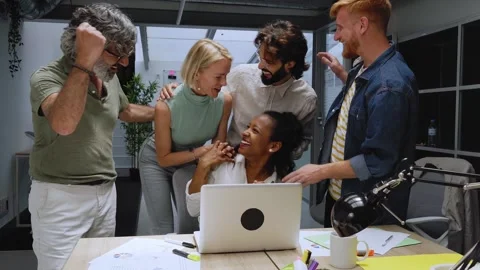 Group of colleagues at the office raising their arms in celebration a good new Stock Footage 246607833