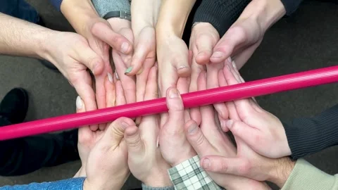 Group of colleagues playing team building games. Team game hovering stick - a Video stock 259082215