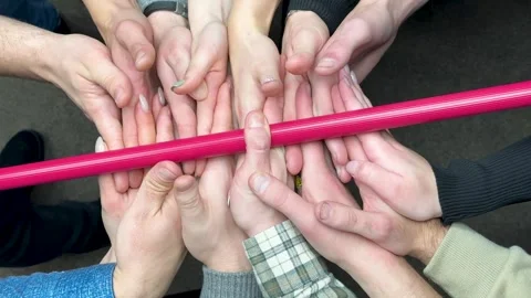 Group of colleagues playing team building games. Team game hovering stick - a Stock Footage 260532750
