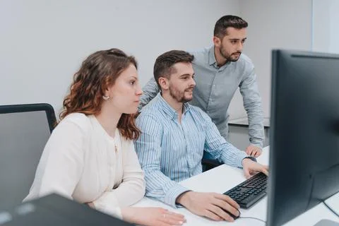 Group of colleagues trying to solve a problem on a computer Stock Photos