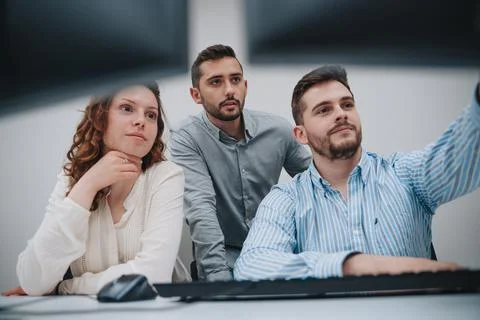 Group of colleagues trying to solve a problem on a computer Stock Photos