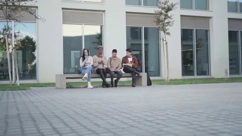 A group of college students looking at their smartphone, addicted to the phone. Stock Footage 221987067