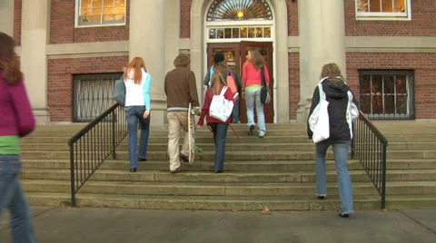 Group of college students walk into building Stock Footage