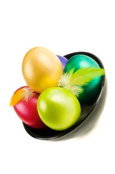 Group of colored Easter Eggs in saucer on white background. Stock Photos