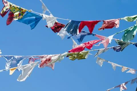 A group of colored shirts on a clothesline Stock Photos
