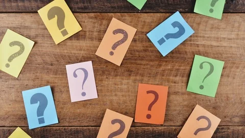 Group of colorful paper with QUESTION MARK moving down on wooden table Stock Footage 92767347