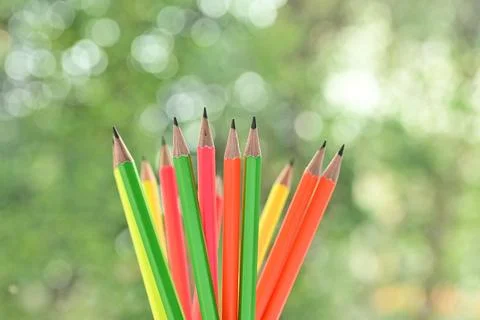 Group of colourful sharp pencil on blur green nature background with bokeh Foto stock