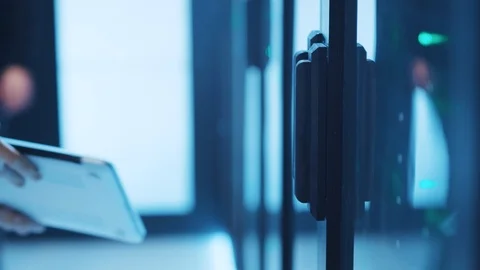 Group of computer hackers sneaking into database, connecting laptop to server Stock Footage 120605147