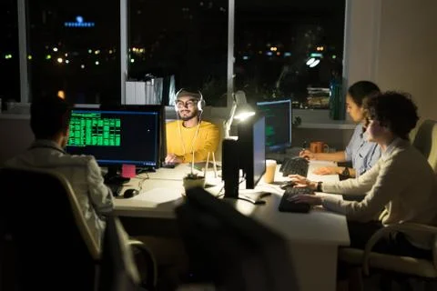 Group of Computer Programmers Coding at Night Stock Photos