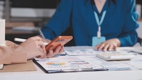 Group of confident business people point to graphs and charts to analyze ma.. Stock Footage 344632053