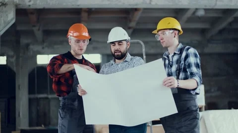 Group of construction engineers are looking at the plan of the facility Stock Footage 136355794