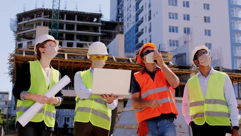Group of construction specialists with protective mask in pandemic in the middle Stock Footage