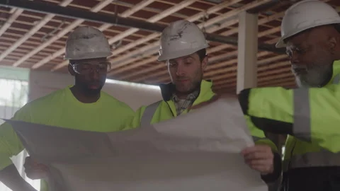 Group Of Construction Workers Looking At Blueprint On Job Site Video stock 270389153
