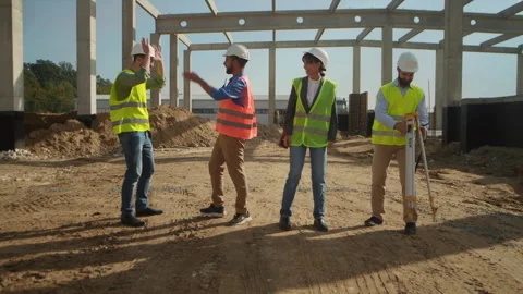 Group of construction workers wearing brightly colored vests and white hard hat Video stock 276235310