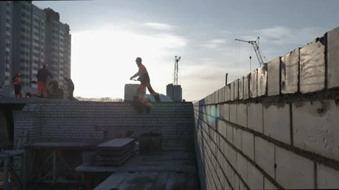 A group of contractors working on a construction site at daytime near the sunset Stock Footage 248290045