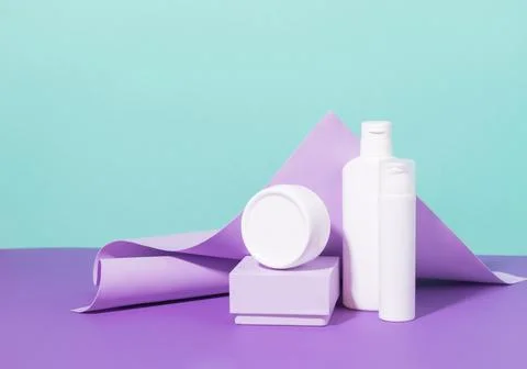 Group of cosmetics in various jars bottles of white packaging on pastel mint Stock Photos