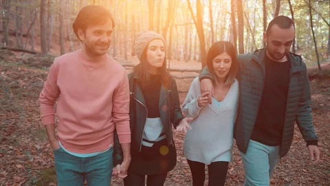 Group of couples are walking and speaking together in a sunny autumn day. Stock Footage 119036200