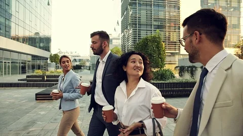 Group of coworkers walking outside in front of office buildings. Stock Footage 120682735