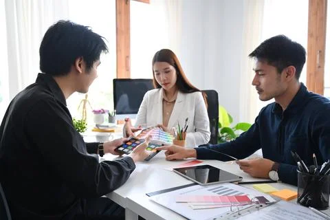 Group of creative designer preparing new project presentation for clients or Stock Photos