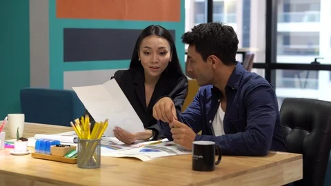 Group of creative designers brainstorming together in the meeting room . Busi Stock Footage 112729916