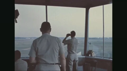 Group of crew works and direct aircraft from air traffic control tower - 1967 Stock Footage
