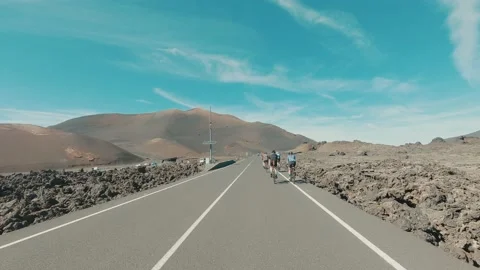 Group of cyclist riding bikes all together in the middle of the road having fun  Stock Footage 172492979