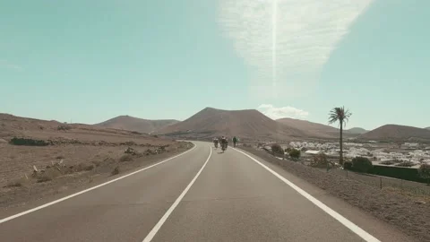 Group of cyclist riding bikes all together in the middle of the road having fun  库存影片 172493065