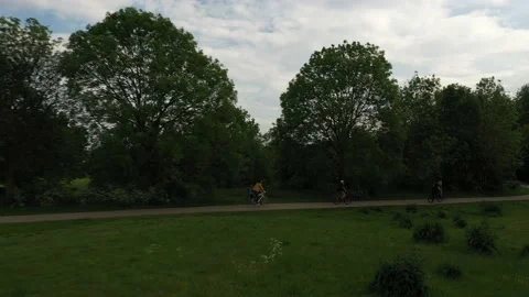Group of cyclist riding on pathway in park Video stock 155830231
