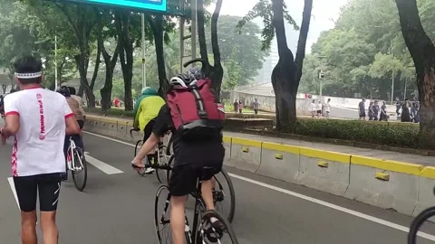 A Group of Cyclists and Runners Crossing the Highway Stock Footage 237621045