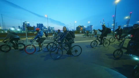 Group of cyclists approaching Silvertown Tunnel London O2 Arena Night Ride Stock Footage 310252827
