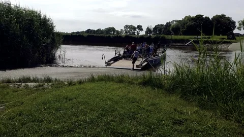 A group of cyclists are ferrying across the canal. Stock Footage 168467314