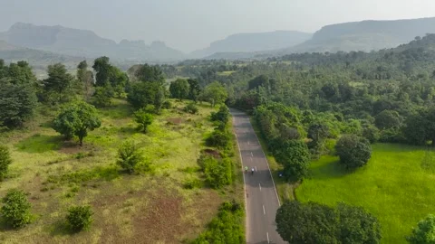 Group of cyclists couple team ride bicycles on winding road in nature surro.. Stock Footage 283984205