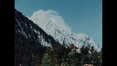 Group of cyclists enjoys lunch underneath Alpine peaks in sun, Austria 1957 Stock Footage 133281392