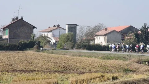 Group of cyclists passes on the road with car traffic Stock Footage 83910108