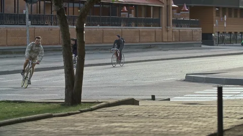 Group of cyclists ride bicycles at empty street. Ecological urban transport Stock Footage 108345923