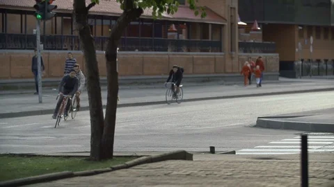 Group of cyclists ride bicycles at empty street. Ecological urban transport Stock Footage 108347813