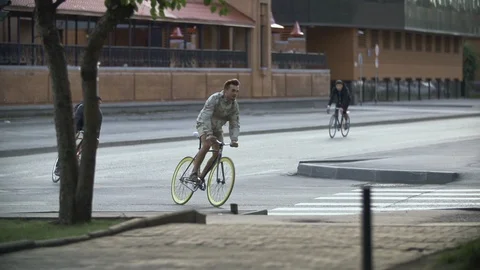 Group of cyclists riding bicycles at empty street. Ecological urban transport Stock Footage 108344997
