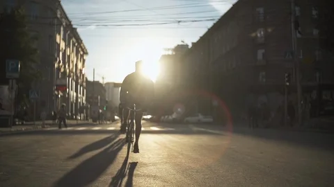 Group of cyclists riding bicycles at sunset street. Eco-friendly urban transport Stock Footage 108320652