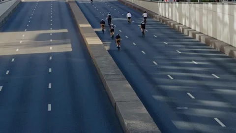 Group of cyclists riding on empty urban highway Video stock 343926452