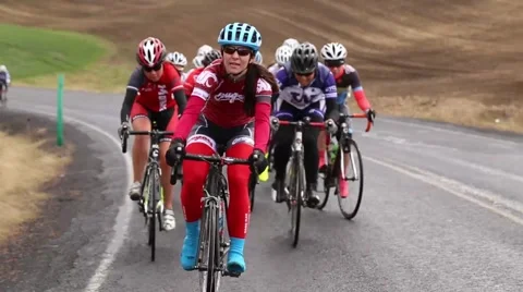 Group of cyclists riding up a hill Stock Footage 50452809
