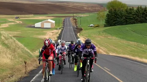 Group of cyclists riding up a hill Stock Footage 50452815